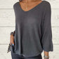 Top tricoté uni pour femme avec col en V et manches chauve-souris